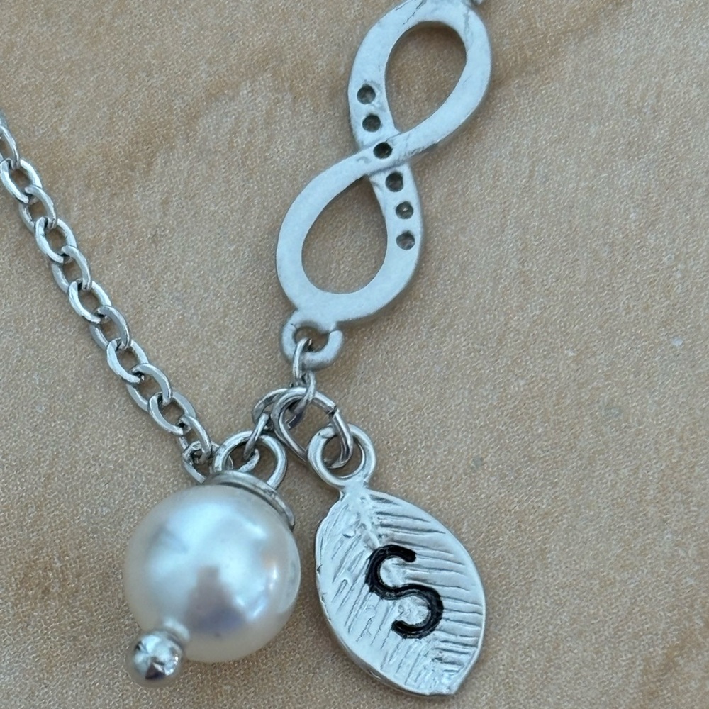 Infinity Bracelet in silver tone/ faux pearl /leaf with “S” /fits wrist size 7 …